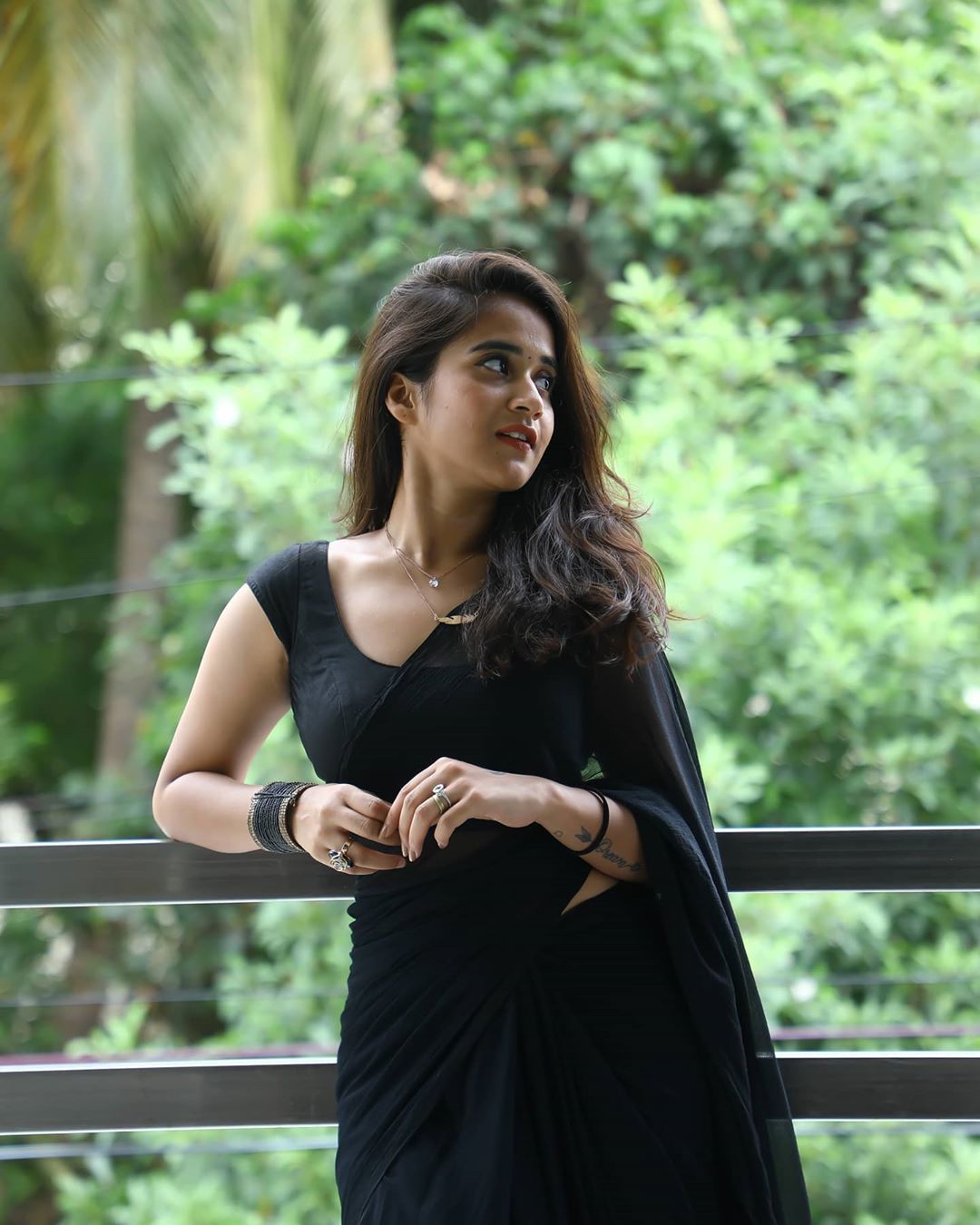 Premium Photo | Portrait of a young beautiful girl wearing traditional black  saree posing on a brown background