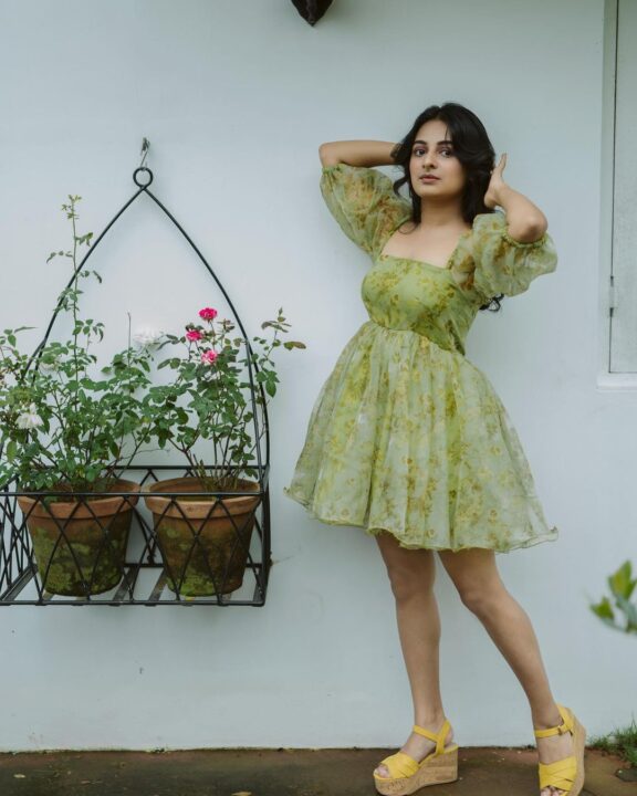 Esther Anil in green floral short frock styled by Arun Dev