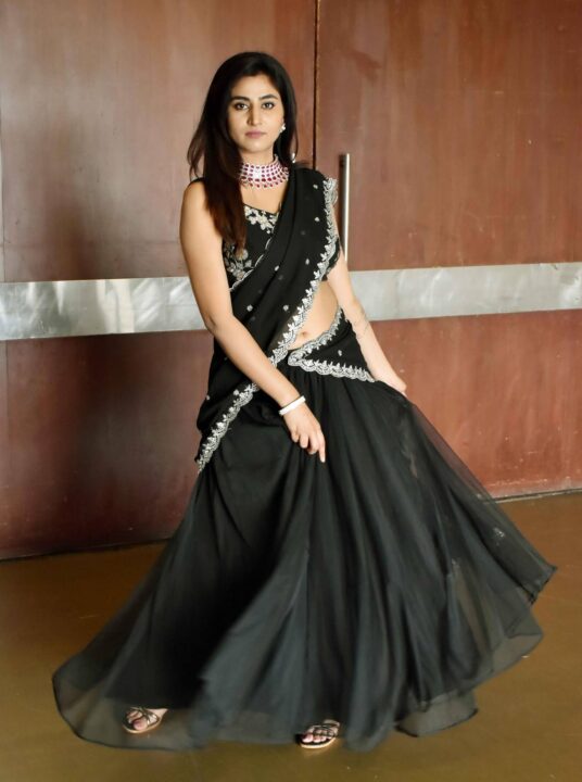 Varshini Sounderajan navel stills in black half saree