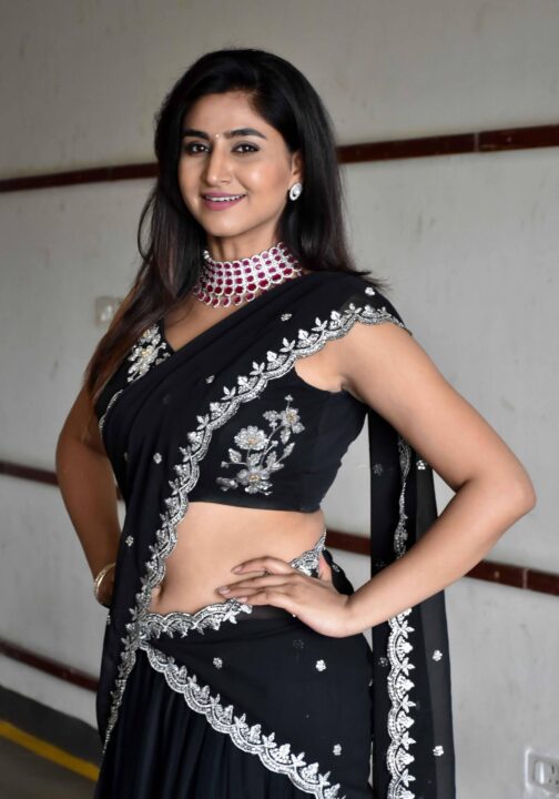 Varshini Sounderajan navel stills in black half saree