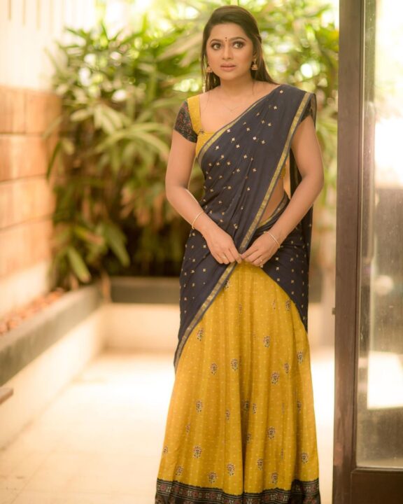 Delna Davis in Megendi Yellow half saree photos