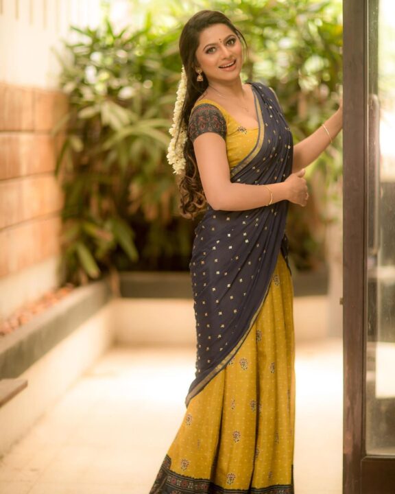 Delna Davis in Megendi Yellow half saree photos