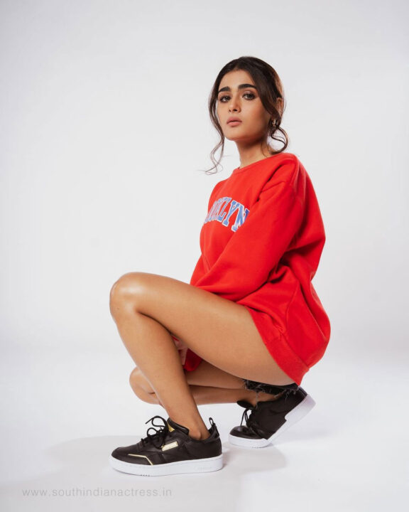 Shalini Pandey in red sweatshirt and black jeans shorts