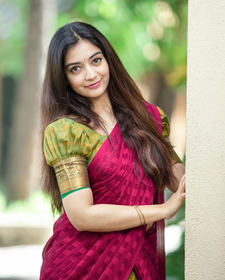 Athmika Sumithran in red and bottle green half saree