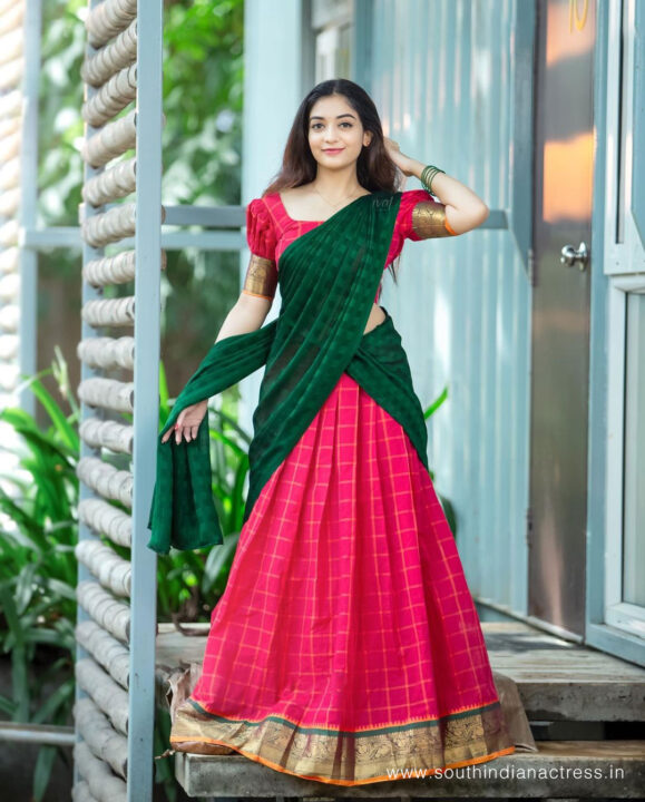 Athmika Sumithran in red and bottle green half saree