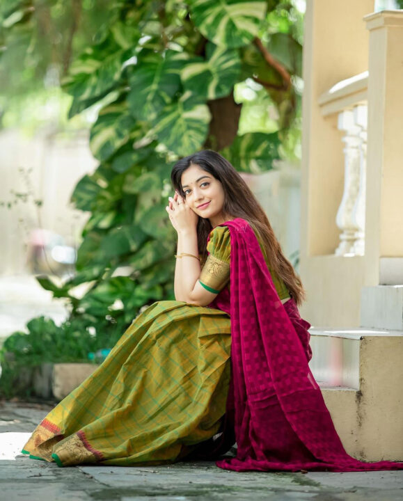 Athmika Sumithran in mehendi green and pink dhavani half saree