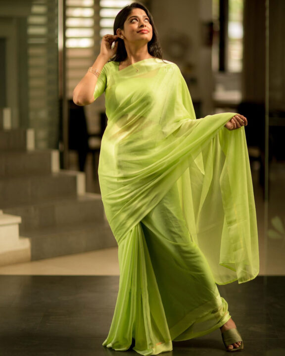 Dharshana Asokan in lime green chiffon saree stills