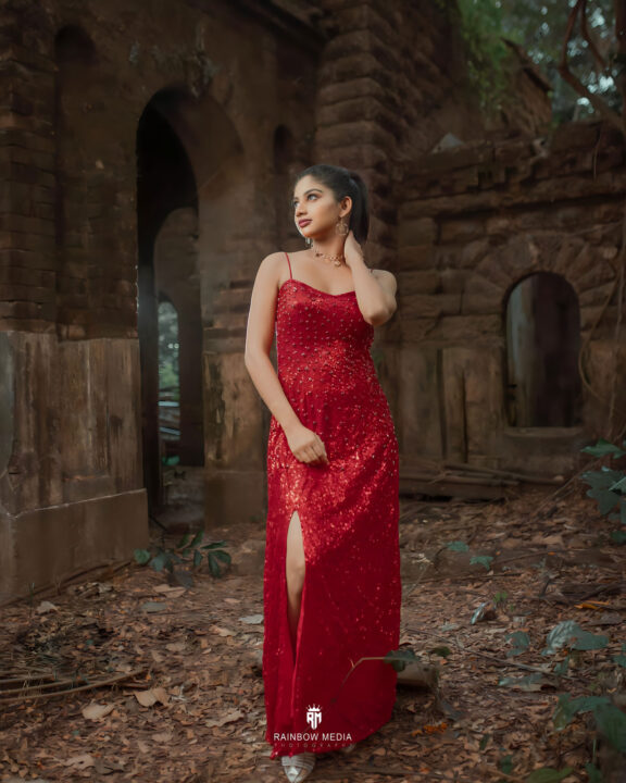 Ann Sindhu stills in red split cocktail dress