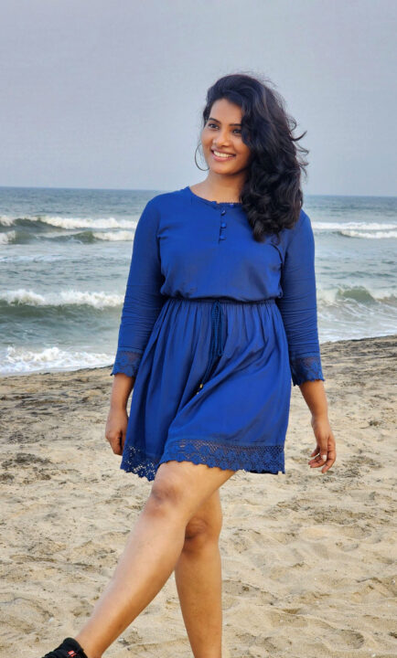 Dhivya Duraisamy in short dress at beach photos