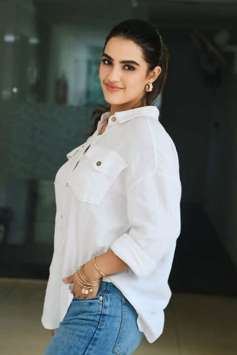 Kavya Thapar Dazzles in Casual White Shirt and Denim at Viswam Success Meet