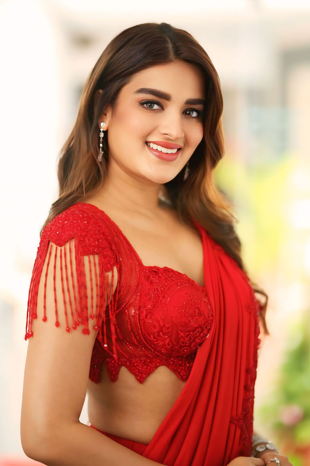 Nidhhi Agerwal Charms in Red Saree for Movie Interview