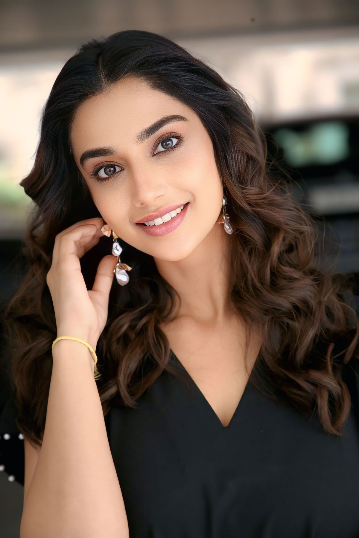 Meenakshi Chaudhary Stuns in RAREISM Black Midi Dress at Anaganaga Oka Raju Interviews